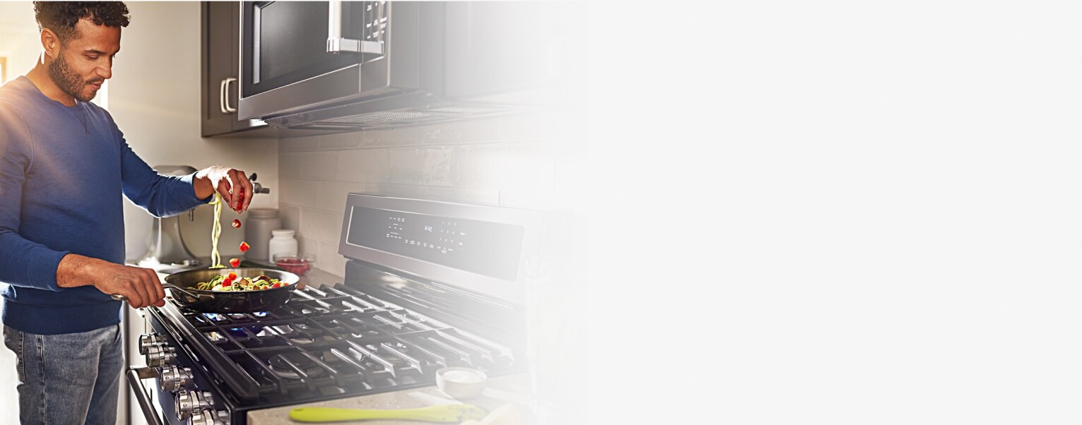 Person cooking on a gas range cooktop