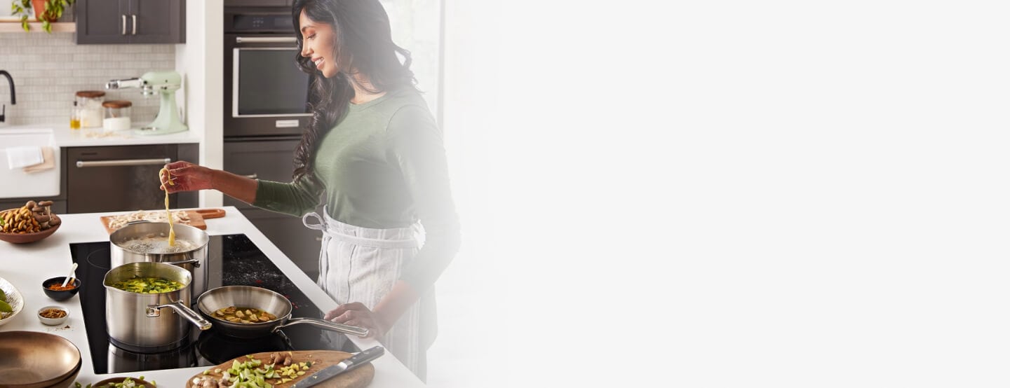 Person cooking on an induction cooktop