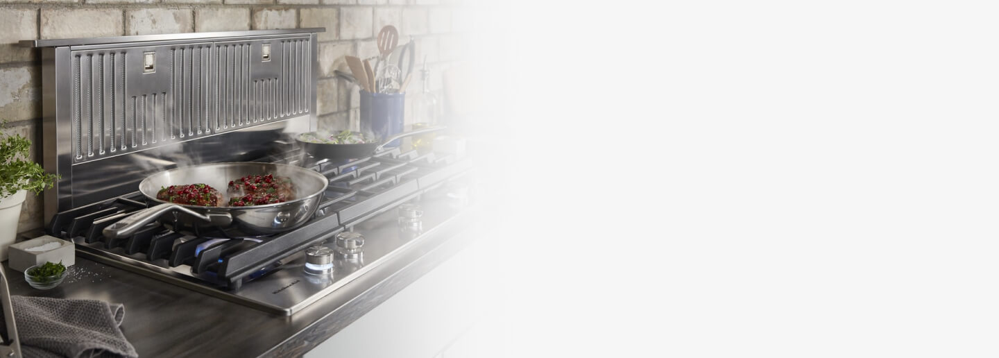 Retractable vent hood and a gas cooktop