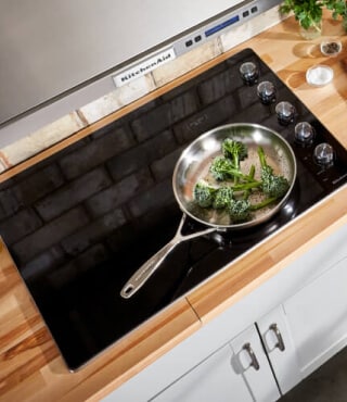 Vegetables sizzling on a cooktop
