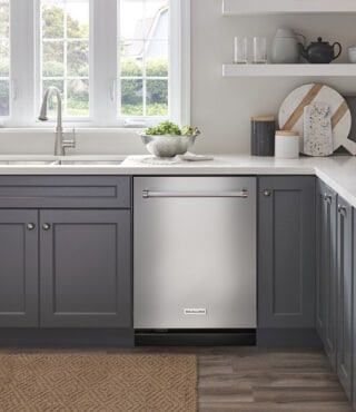 A built-in KitchenAid® dishwasher in a kitchen with gray cabinets