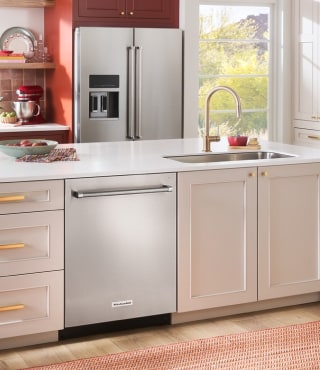 A stainless steel dishwasher and refrigerator in a kitchen