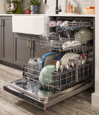 An open dishwasher with dishes inside