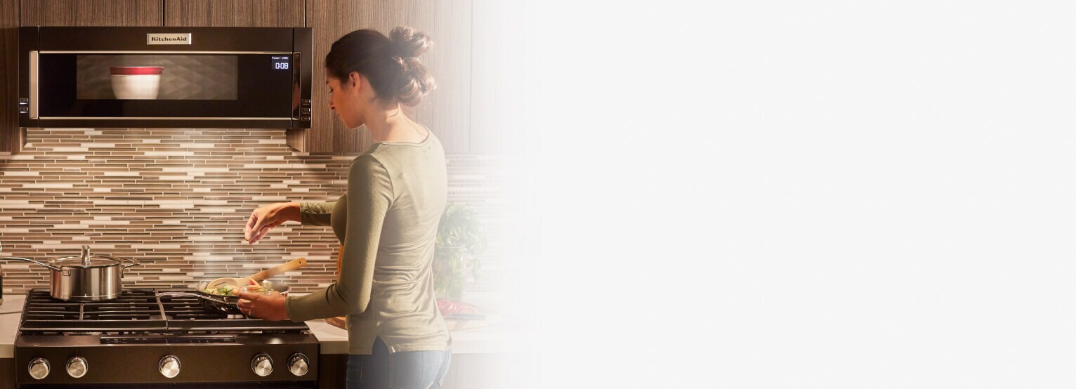 Person cooking on a gas range cooktop