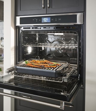 Vegetables roasting in an opened oven