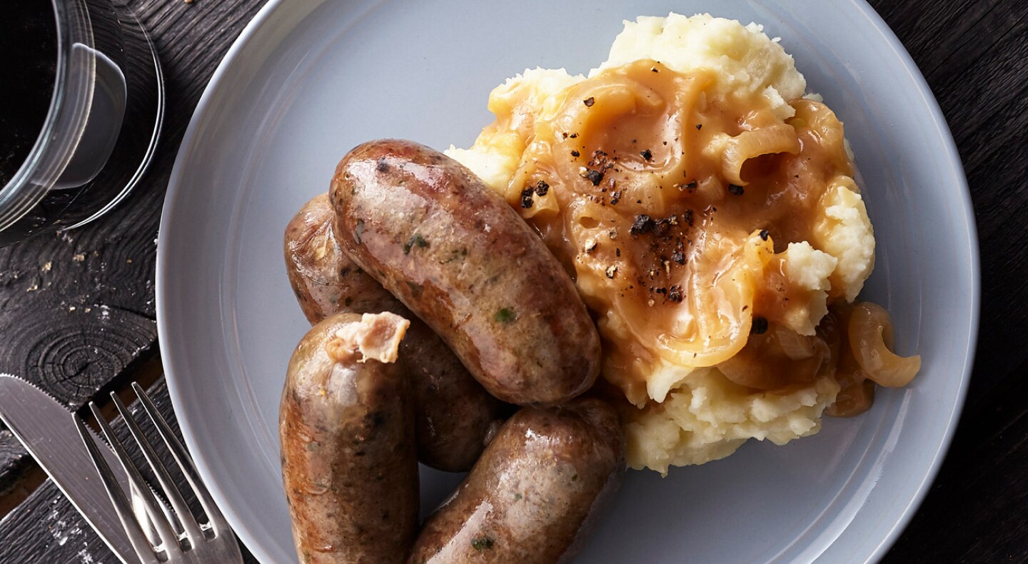 Sausage and mashed potatoes covered with gravy Sausage and mashed potatoes covered with gravy