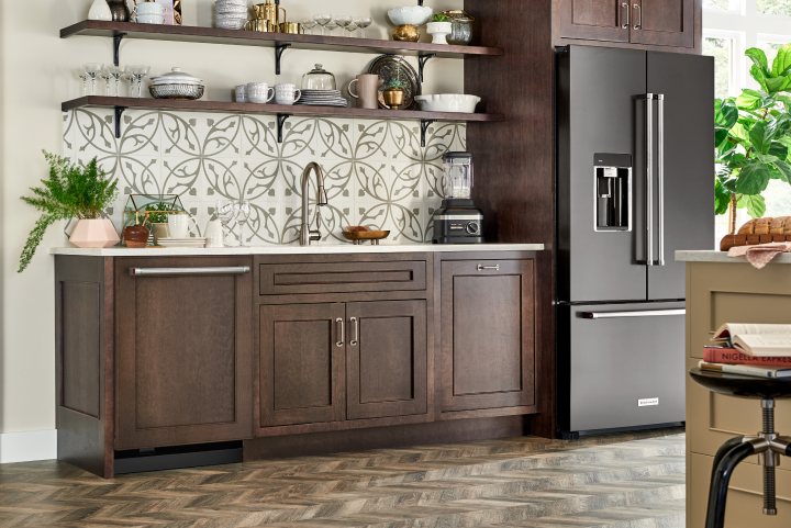 A KitchenAid® refrigerator with a sleek black finish in a modern kitchen A KitchenAid® refrigerator with a sleek black finish in a modern kitchen