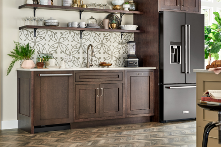 A KitchenAid® refrigerator with a sleek black finish in a modern kitchen A KitchenAid® refrigerator with a sleek black finish in a modern kitchen