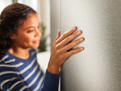 Woman opening freezer door