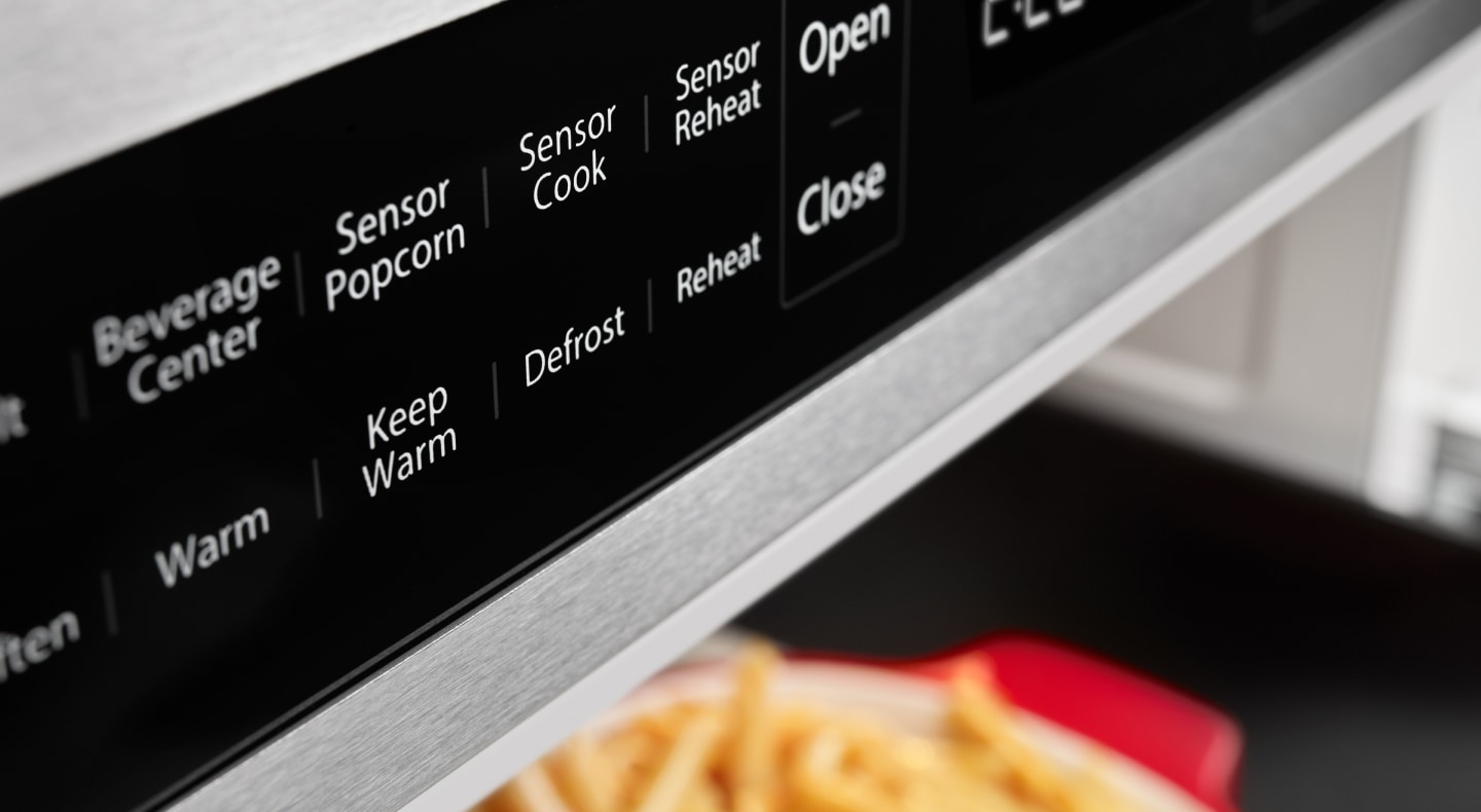 A close up of microwave controls A close up of microwave controls