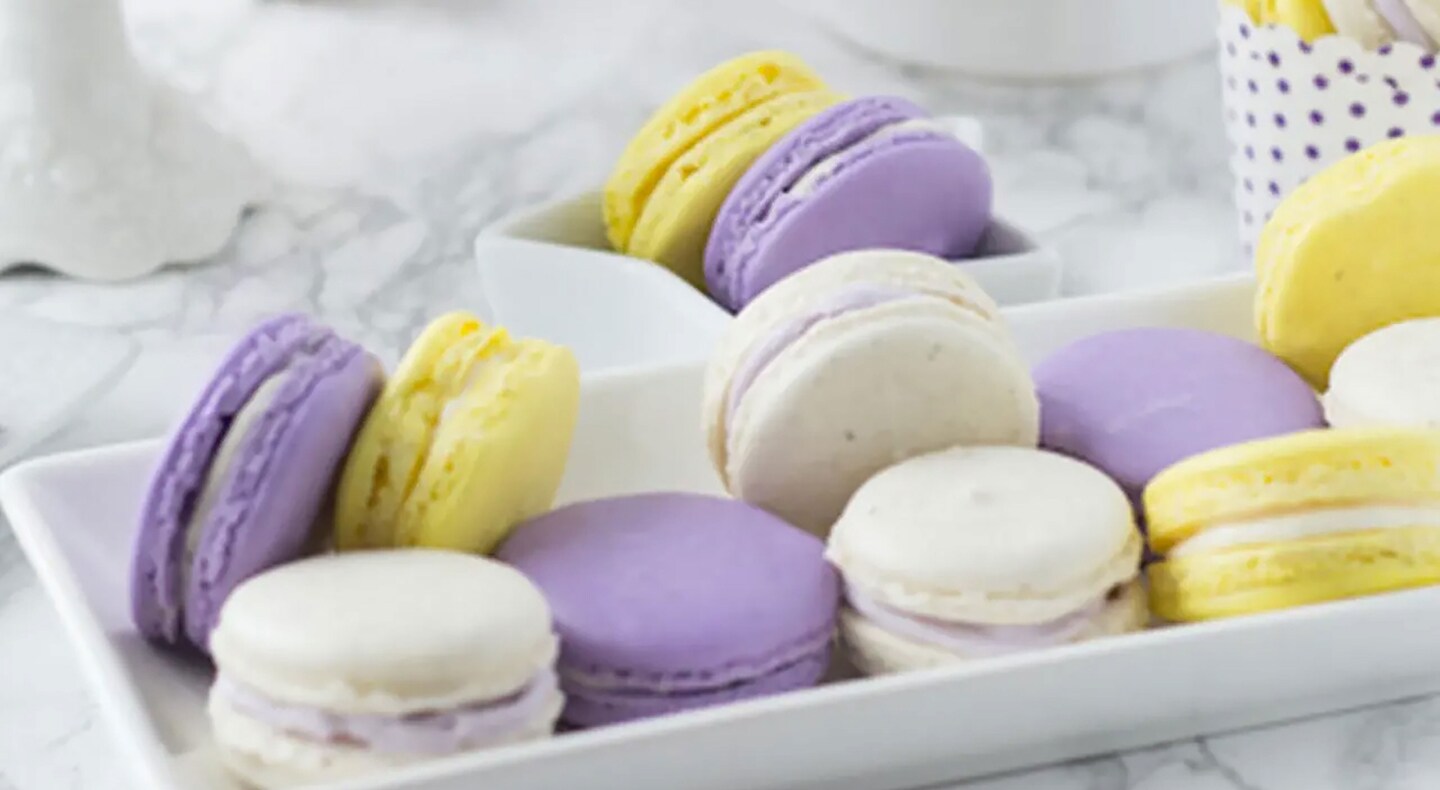 Lavender honey macarons on a serving tray. Lavender honey macarons on a serving tray.