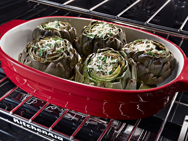 Vegetables in a roasting pan in an oven