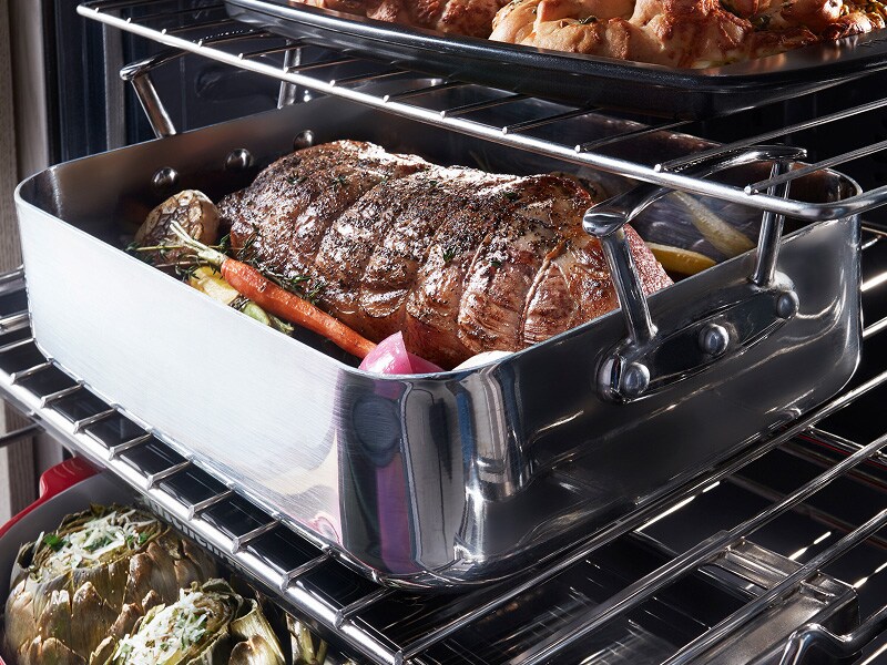 A roast with vegetables inside an oven