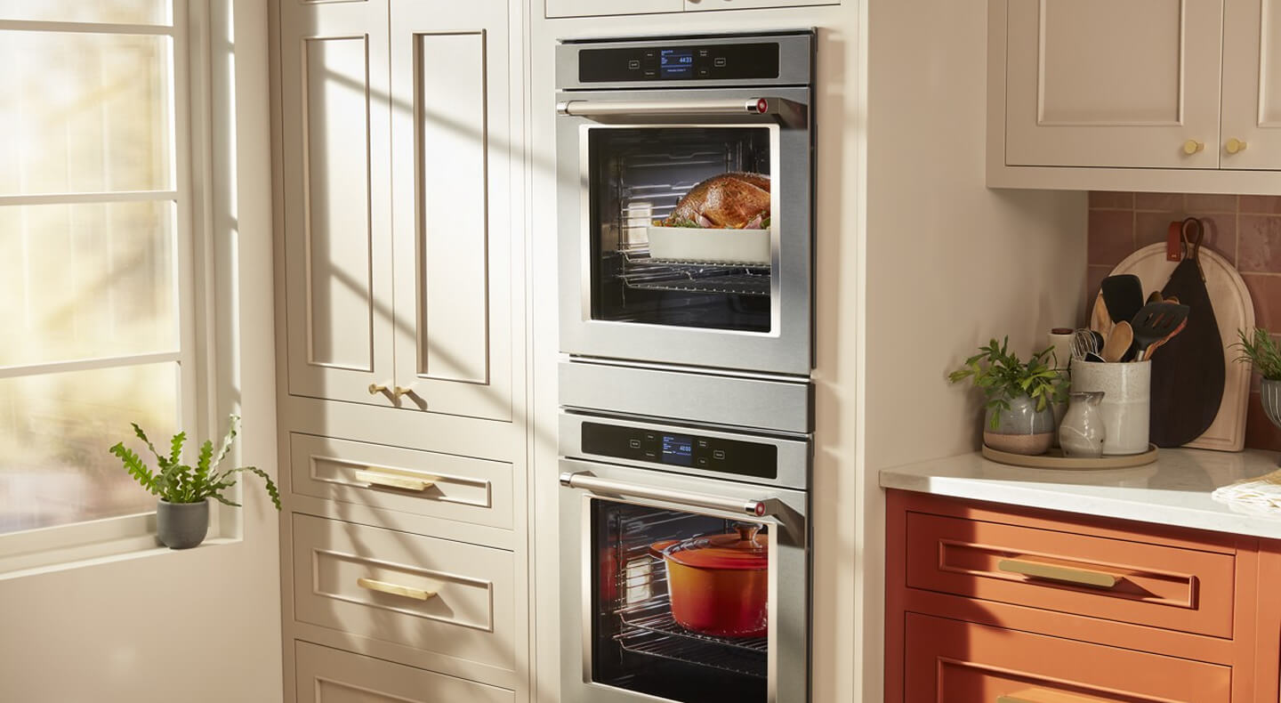A brightly lit kitchen with a KitchenAid® double wall oven