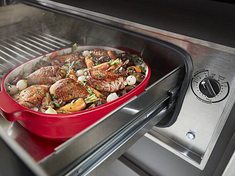 A roast and vegetables in a warming drawer