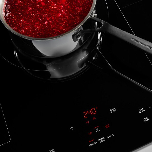 Jam cooking in a saucepan on an induction cooktop