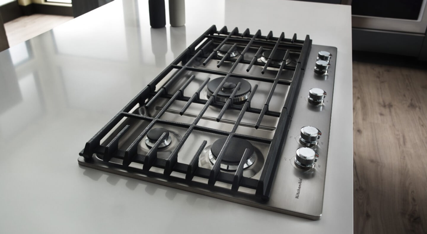 Gas cooktop on a white kitchen counter