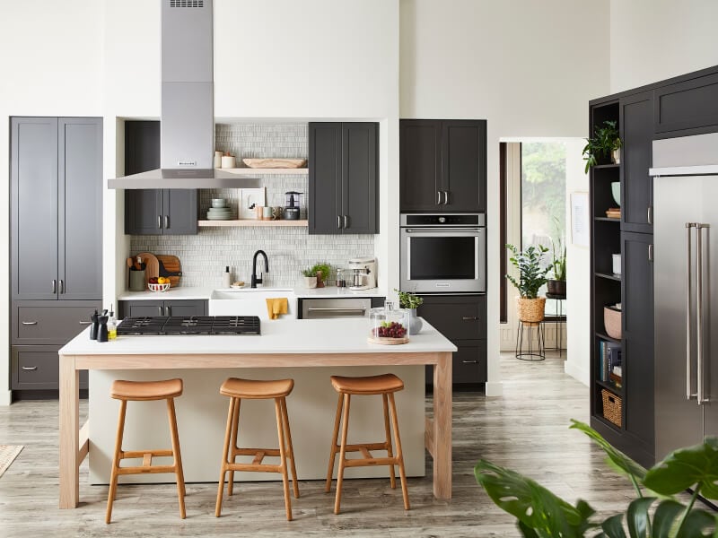 Kitchen island in front of sink and dishwasher next to wall oven 
