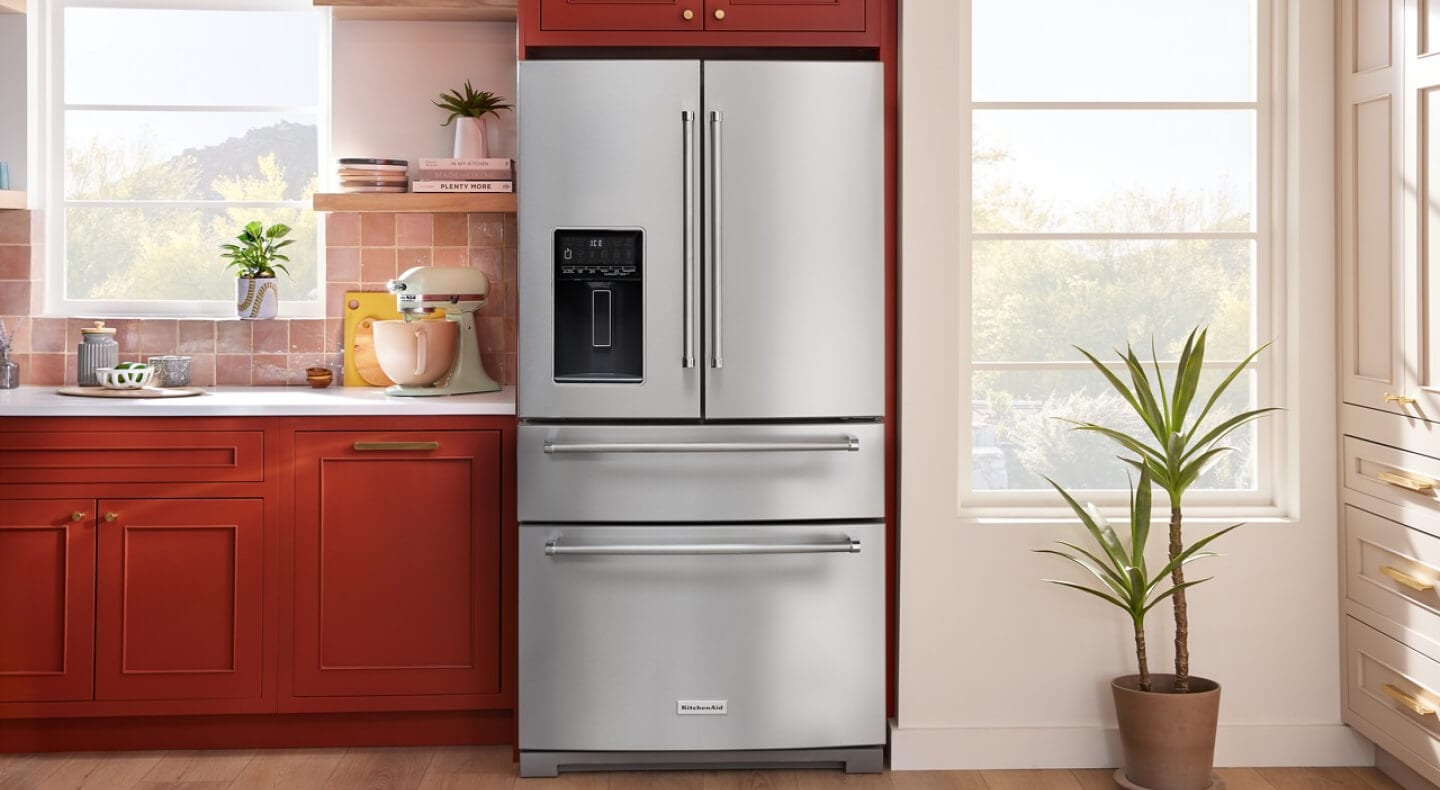 French door KitchenAid® refrigerator against dark terracotta cabinetry