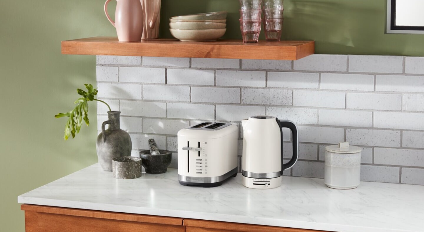 Off white KitchenAid® toaster and kettle on a countertop Off white KitchenAid® toaster and kettle on a countertop