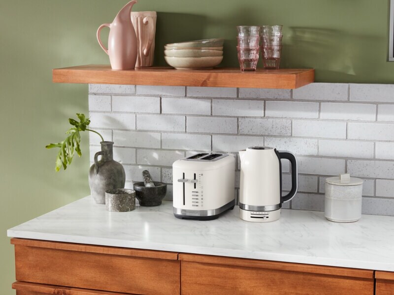 Off white KitchenAid® toaster and kettle on a countertop Off white KitchenAid® toaster and kettle on a countertop
