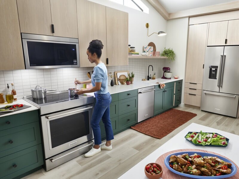 Person making chicken wings and an assortment of vegetables Person making chicken wings and an assortment of vegetables