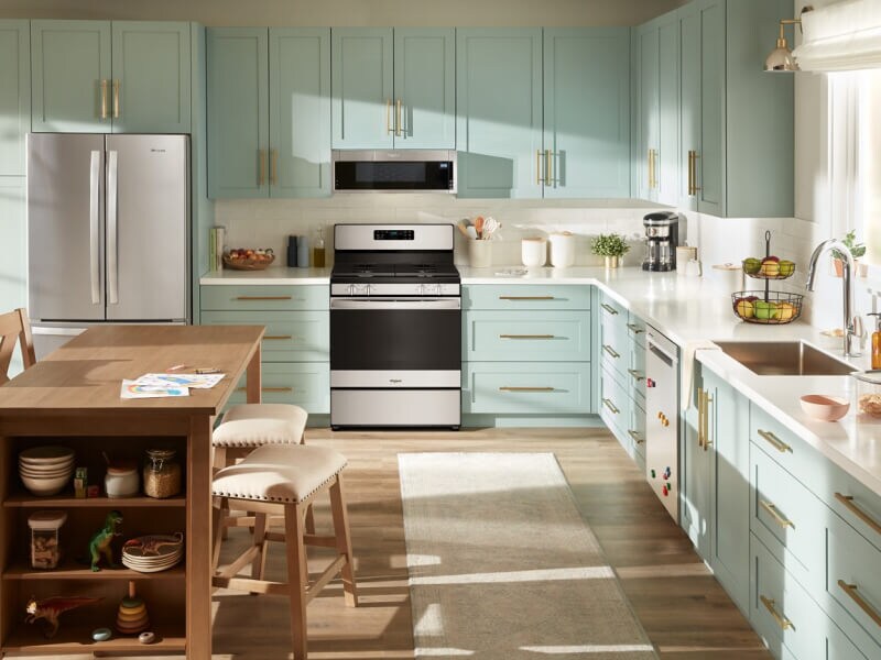 Light blue and white kitchen with stainless steel appliances