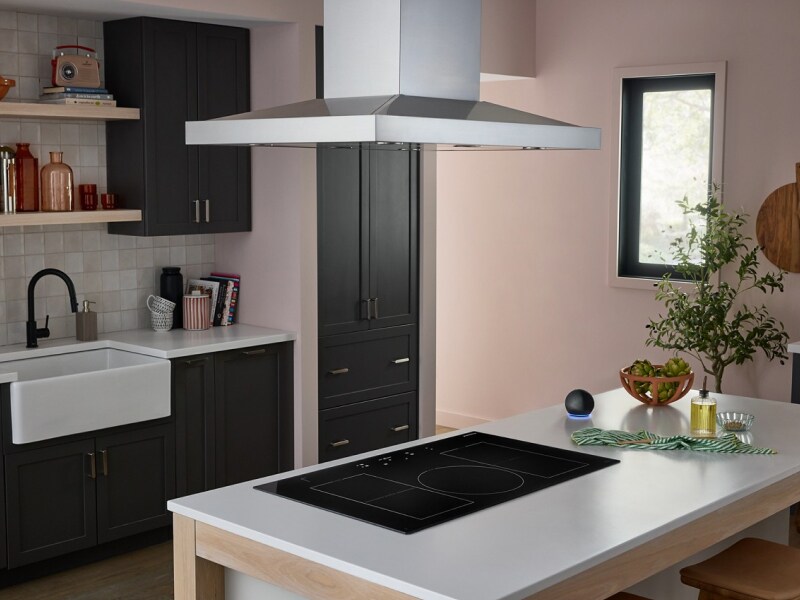 Kitchen island with an electric cooktop and canopy vent hood