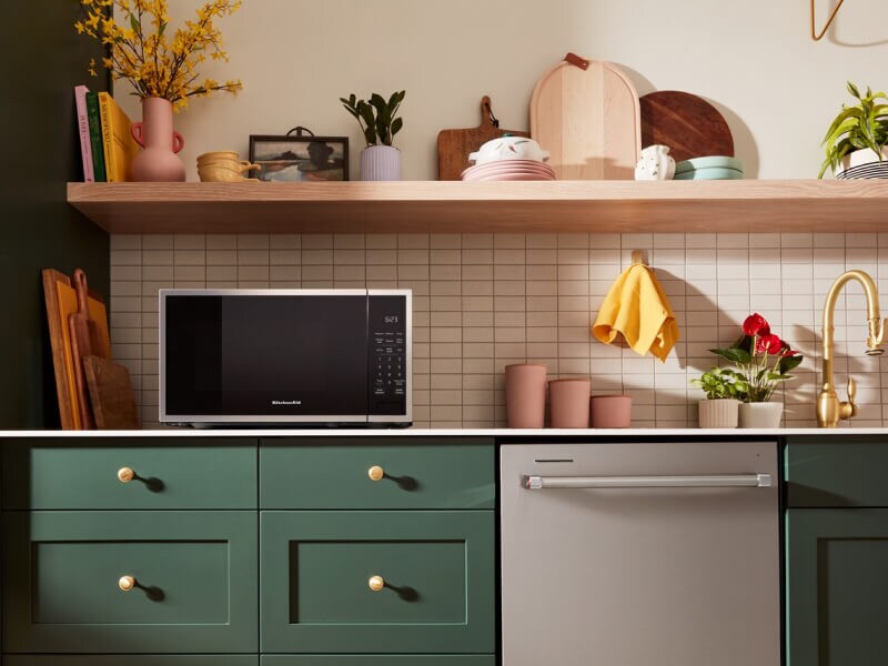 Countertop microwave and top control dishwasher in a green kitchen