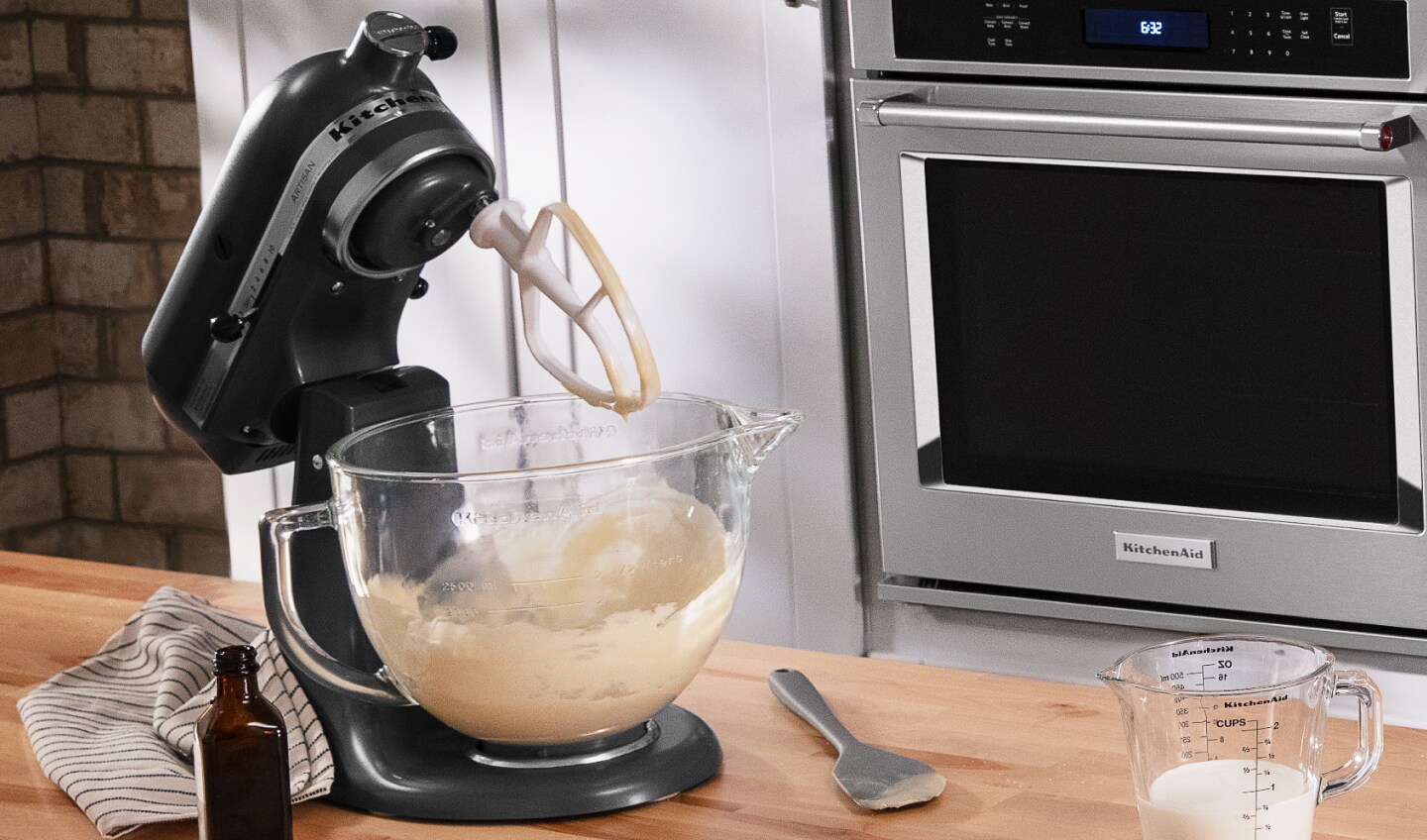 Black KitchenAid® stand mixer with Flat Beater Accessory and ingredients next to it Black KitchenAid® stand mixer with Flat Beater Accessory and ingredients next to it