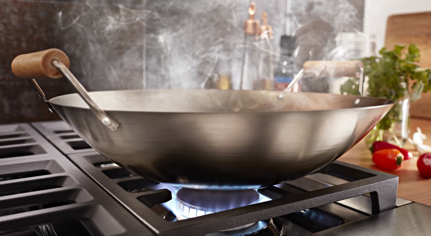 Close-up of a wok on a gas range