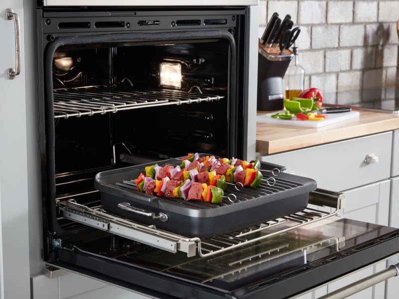 An oven light bulb illuminating an open oven