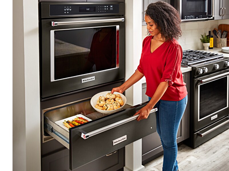 Placing food into a warming drawer 