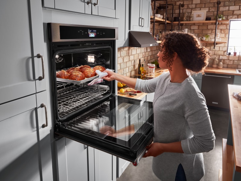Removing cooked food from an oven  Removing cooked food from an oven