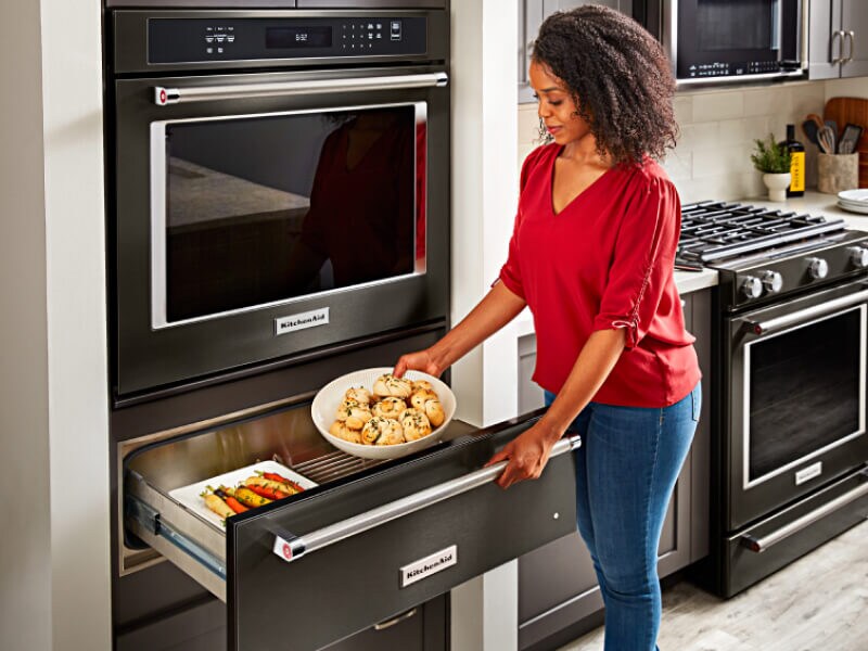 Placing food into a warming drawer 