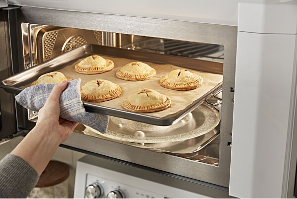 Person removing food from a microwave