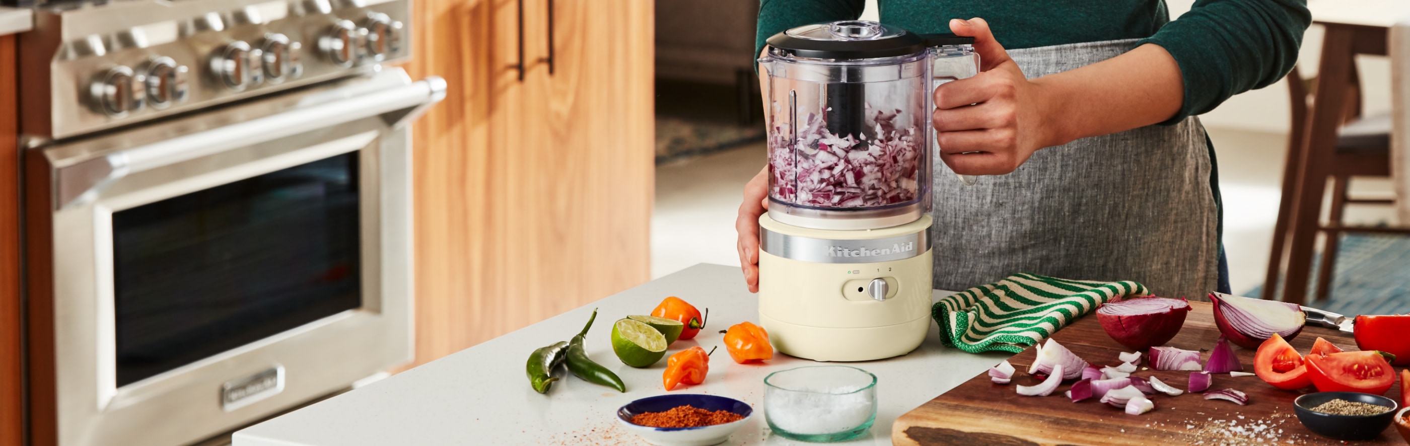 Woman chopping onions in a KitchenAid® Food Processor