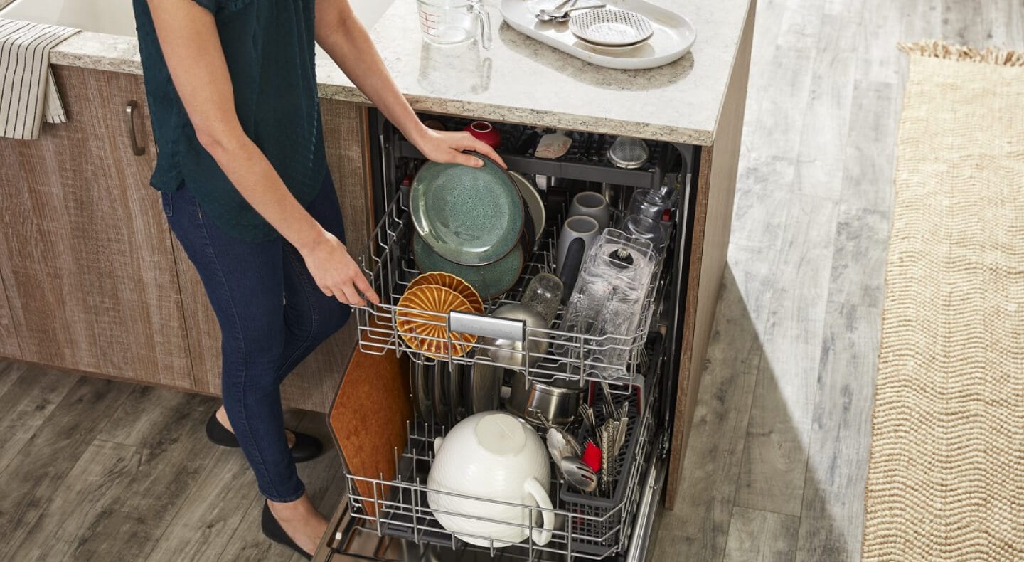 Person loading a dishwasher