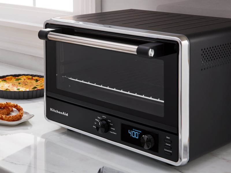KitchenAid® countertop oven with onion rings on a tray KitchenAid® countertop oven with onion rings on a tray