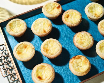 Sweet cheese tarts on blue serving tray Sweet cheese tarts on blue serving tray