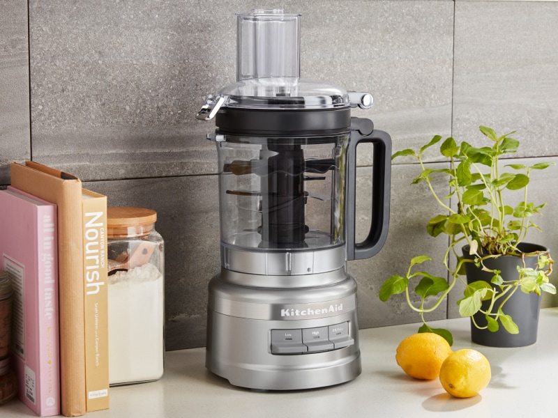Large silver food processor on the counter with lemons Large silver food processor on the counter with lemons