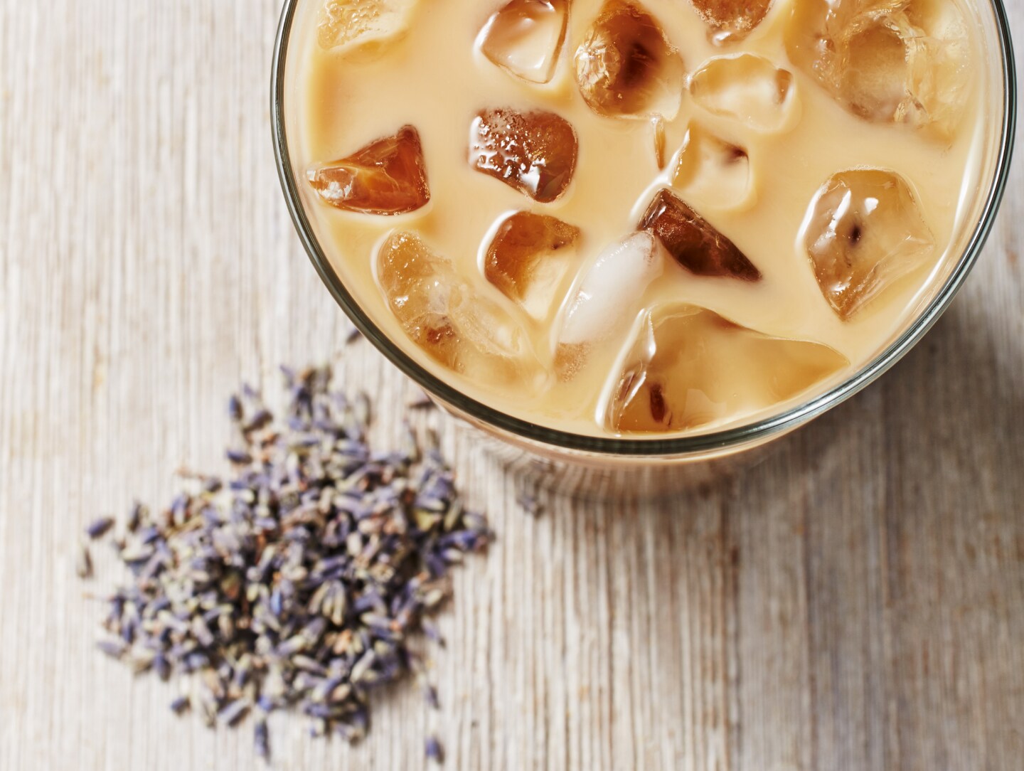 Iced coffee drink with fresh lavender buds on countertop  Iced coffee drink with fresh lavender buds on countertop