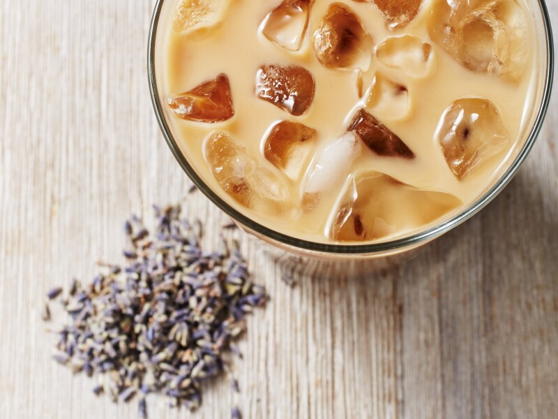 Iced coffee drink with fresh lavender buds on countertop  Iced coffee drink with fresh lavender buds on countertop