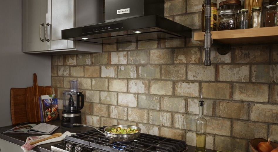 KitchenAid® range hood in kitchen with brick backsplash KitchenAid® range hood in kitchen with brick backsplash
