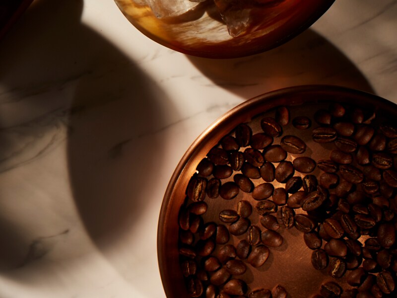 Copper bowl filled with coffee beans