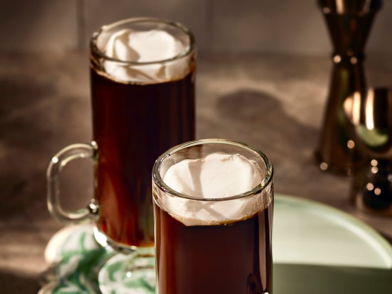 An espresso drink with a dollop of whipped cream.