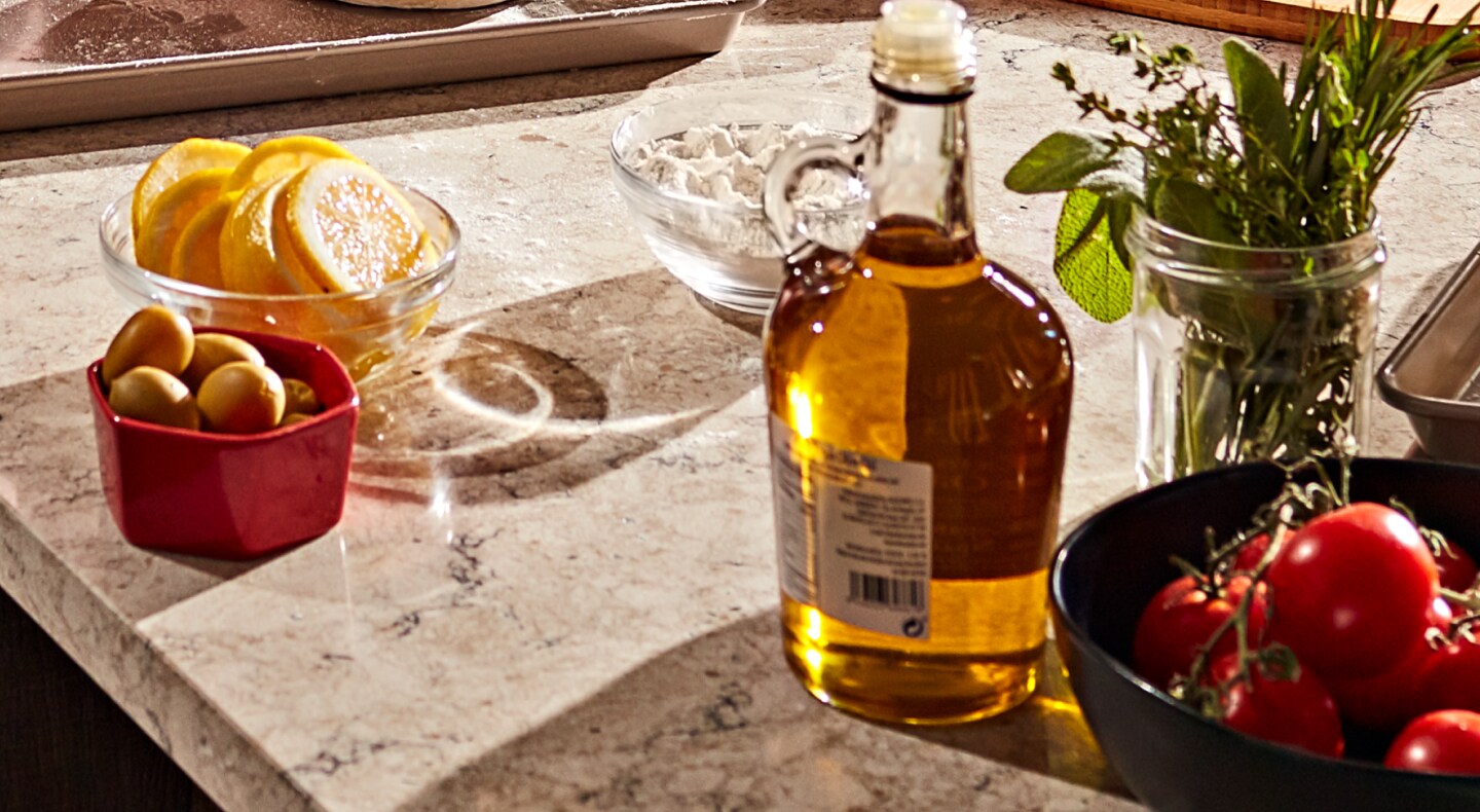 Sliced lemons, cherry tomatoes, herbs and a jar of vinaigrette. Sliced lemons, cherry tomatoes, herbs and a jar of vinaigrette.