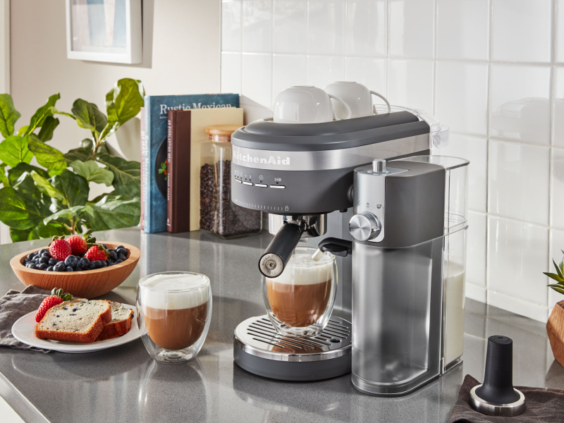 Espresso machine and lattes on countertop with breakfast items Espresso machine and lattes on countertop with breakfast items