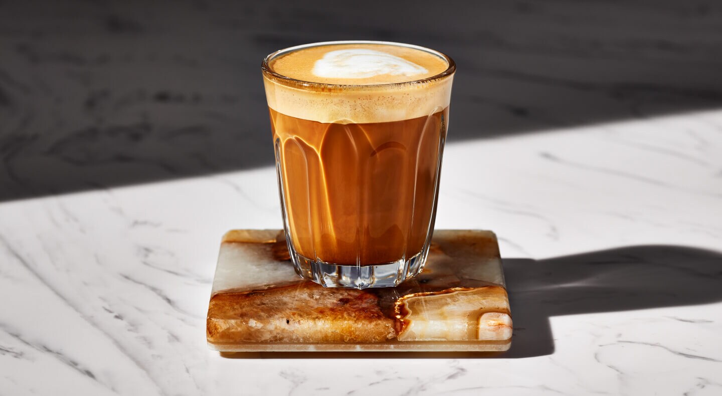 Espresso drink in a glass on a coaster Espresso drink in a glass on a coaster