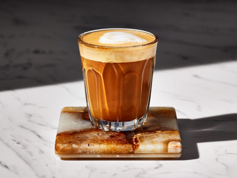 Espresso drink in a glass on a coaster Espresso drink in a glass on a coaster